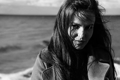 Portrait of beautiful young woman near the sea