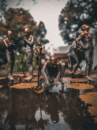 Statue by trees against blurred background