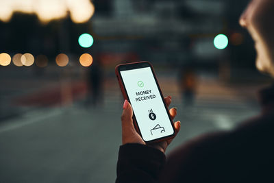 Money transfer. online banking. woman receiving money online using application on mobile phone