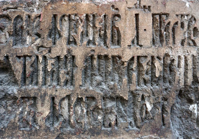 Close-up of text on brick wall