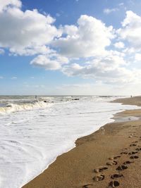 Scenic view of sea against cloudy sky