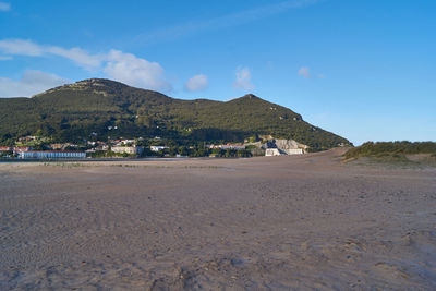 Scenic view of beach against blue sky