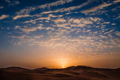 Scenic view of silhouette mountains against sky during sunset