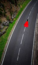 High angle view of red arrow symbol on road in city