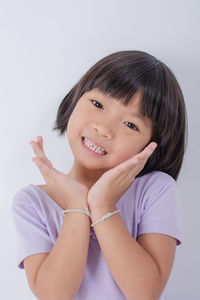Portrait of young woman against white background