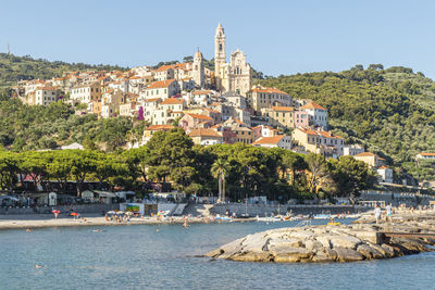 View of town by sea against sky