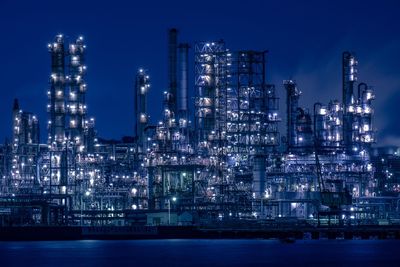 Illuminated city against sky at night