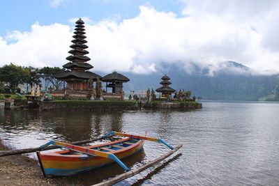 Ship moored at lake against sky