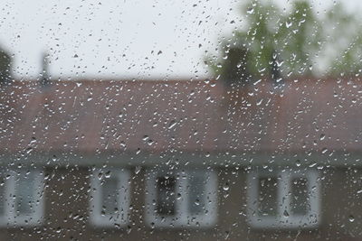 Full frame shot of wet glass window during rainy season