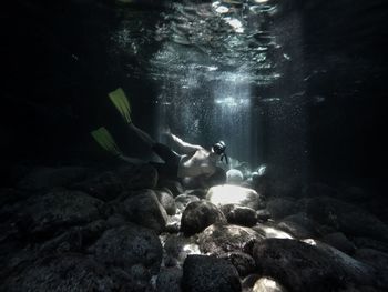 Low section of person swimming in sea