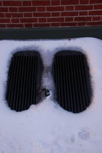 Snow covered metal grate on window
