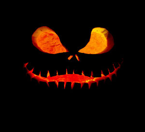 Close-up of illuminated pumpkin against black background