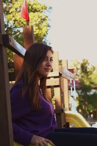 Portrait of beautiful young woman sitting in car