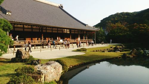 Built structure by lake against sky