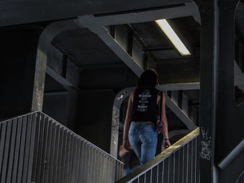 Young woman on staircase at night