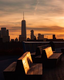 Silhouette buildings against sky during sunset