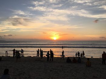 People on beach at sunset