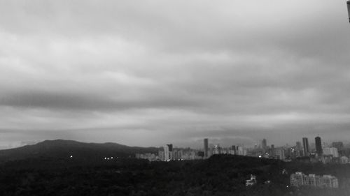 Scenic view of buildings in city against sky