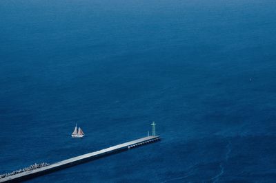 High angle view of sailboat sailing in sea