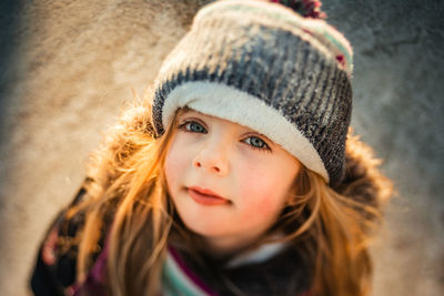 Winter portrait of a 5 years old girl looking at the camera