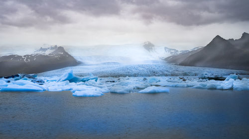 Scenic view of snowcapped mountains against sky