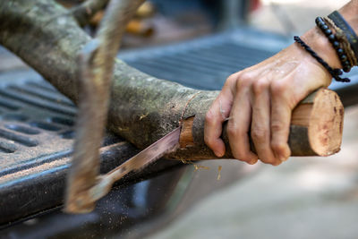 Close-up of man working on wood