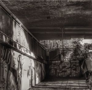 Rear view of man walking on staircase of building