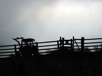 Silhouette railing against sky