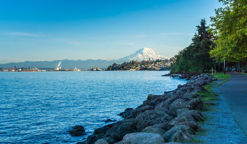 A view of mount rainier and the shoreline in ruston, washington.