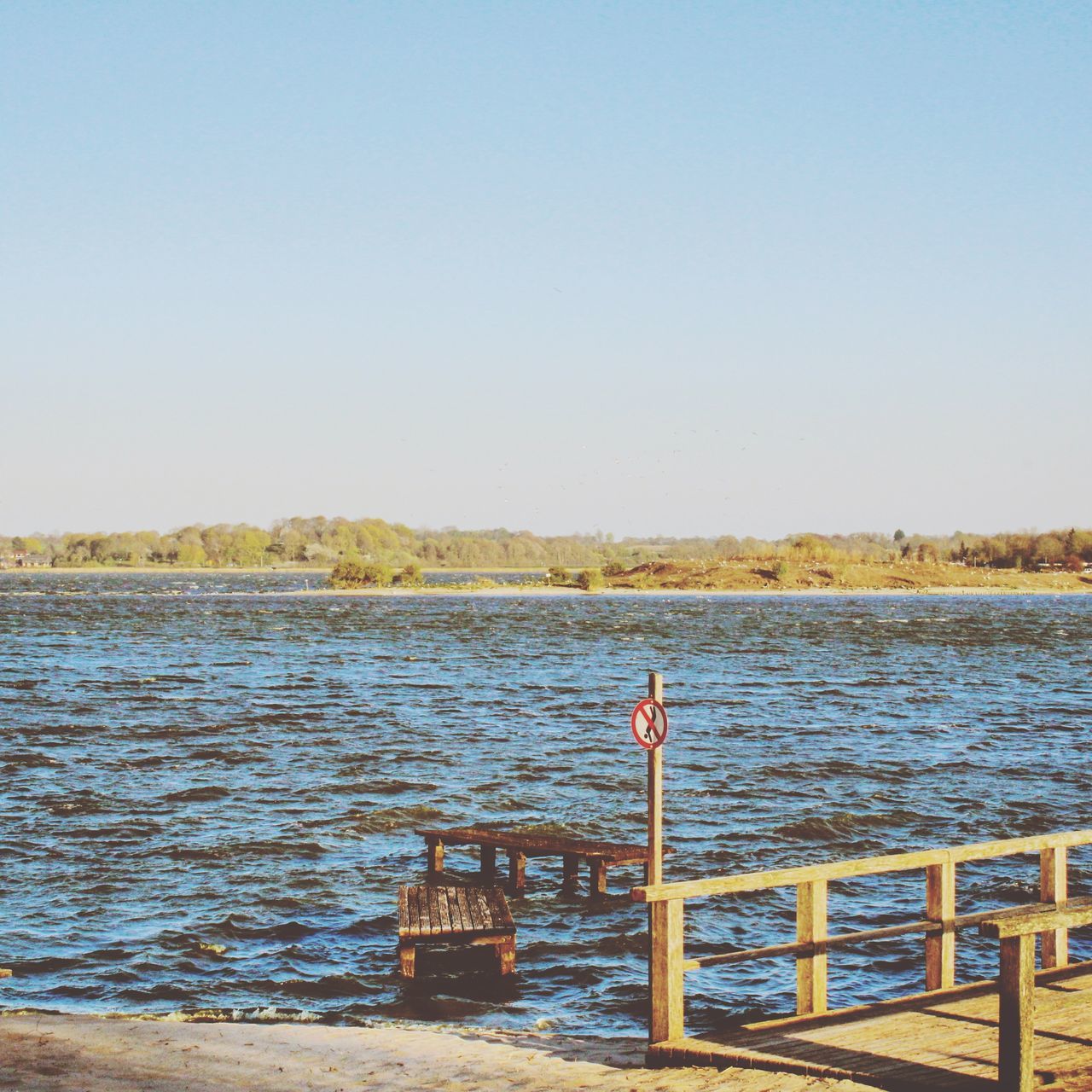 PIER AMIDST SEA AGAINST CLEAR SKY