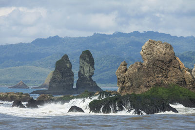 Scenic view of sea and rocks against sky