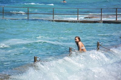 Full length of young woman in swimming pool