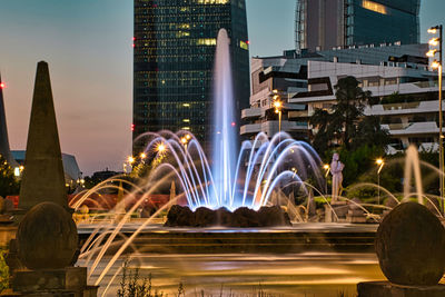 Illuminated city buildings at night