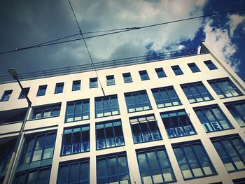 Low angle view of building against cloudy sky