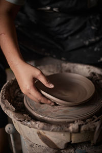 Midsection of potter making pottery
