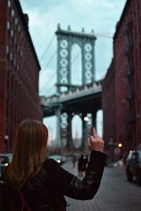 Rear view of woman giving middle finger in brooklyn