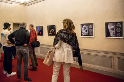 Rear view of people standing in museum