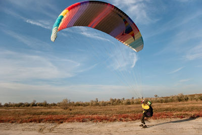 Man paragliding on landscape