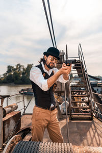 Full length of man standing on boat against sky