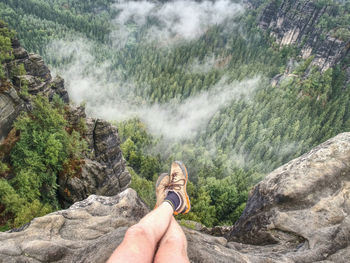 Reached summit of mountain peak. climbing and hiking sport concept. tourist take a rest