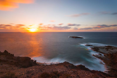 Scenic view of sea against sky during sunset