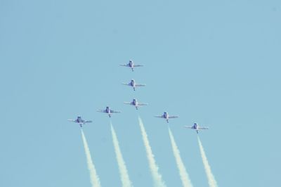 Low angle view of airplane flying against clear sky