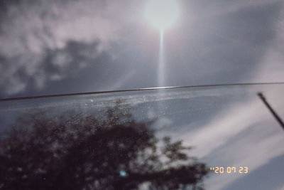 Reflection of sky on glass window of airplane