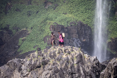 High angle view of man standing on rock