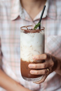 Midsection of woman holding drink