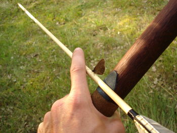 Close-up of hand on grass