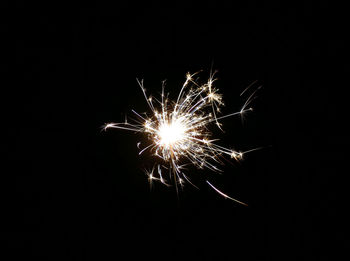 Low angle view of firework display at night