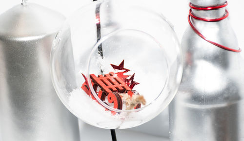 High angle view of red chili peppers in glass container on table
