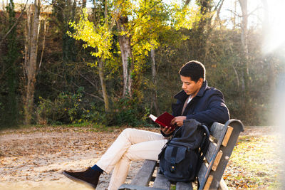 Young man sitting on bench