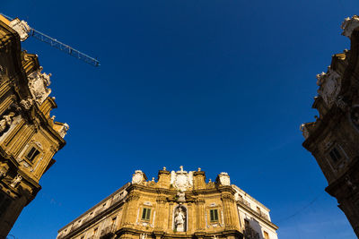 Low angle view of buildings against blue sky